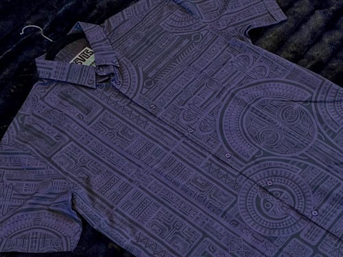 Customer's purple Taerea Tatau shirt laid out flat, showing the intricate tatau pattern.