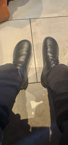 Customer's top-down view of the black Noble Ⅰ - Barefoot Shoes on a tiled floor.