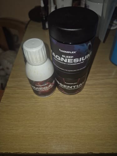Reviewer's Everyday Essentials Bundle, showing the Omega-3, Magnesium, and Multivitamin containers on a wooden table.