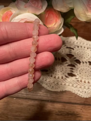 Customer holding the Accent Pink Jade Crystal bracelet, showing its soft pink color and faceted beads.