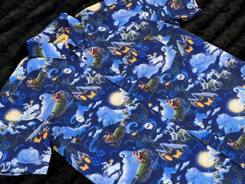 Customer's blue 'Nightmare Before Christmas' shirt laid flat, showing the all-over print of Jack Skellington as Sandy Claws.