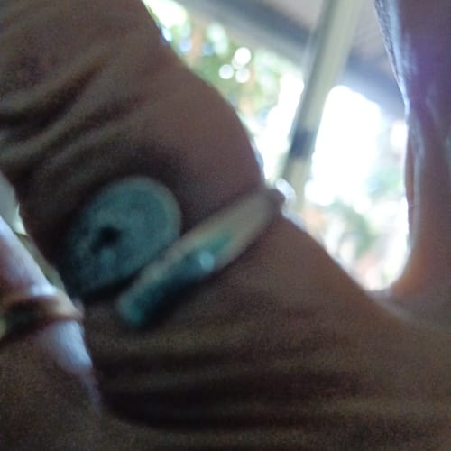 Close-up: A customer's blurry photo of the To My Daughter - Forever Linked Ring on their finger.