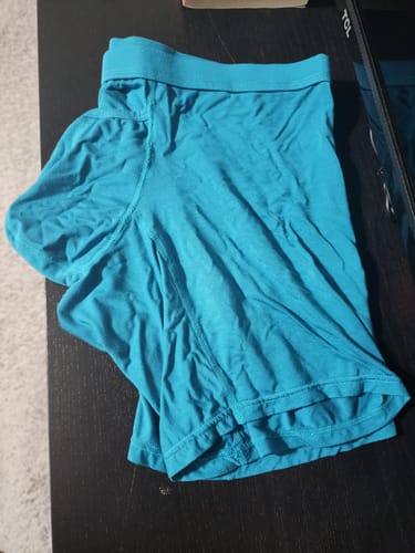 Customer's cyan Modal 7in Boxer Briefs from the 3-pack, laid out wrinkled on a dark surface.