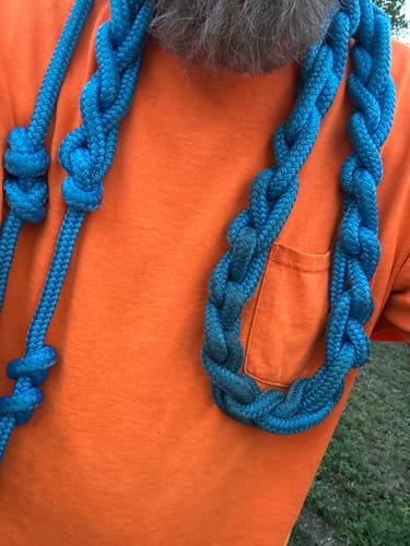 Reviewer with the blue, braided RMT® Infinity Braid Rope draped around their neck.