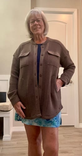 Reviewer stands indoors wearing the Oaklynn Waffle Shacket in Latte, worn open over a top with a hand in the pocket.