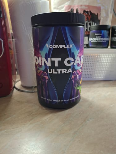 Reviewer's tub of Joint Care Ultra supplement sitting on a kitchen counter.