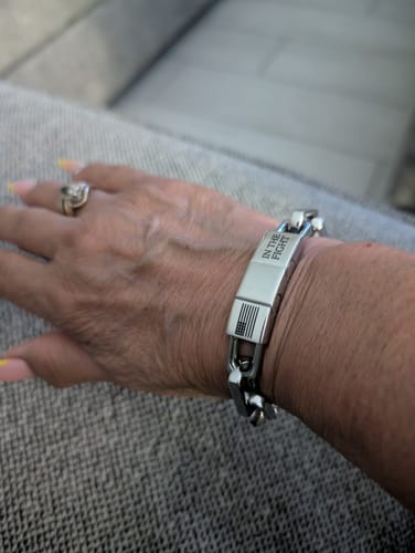 Customer's wrist wearing the polished In The Fight chainlink bracelet, showing the engraved clasp.