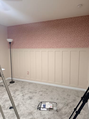 Reviewer's room with pink Penelope Wallpaper applied above beige board and batten wainscoting.