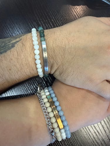 Customer shows their repaired 'Mama Bear' bracelet alongside a new matching 'Rock of our Family' bracelet.