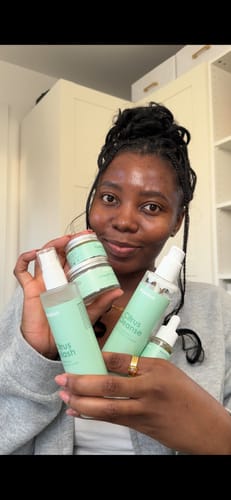 Reviewer happily holding the collection of products from the 5-Step Kit Box.