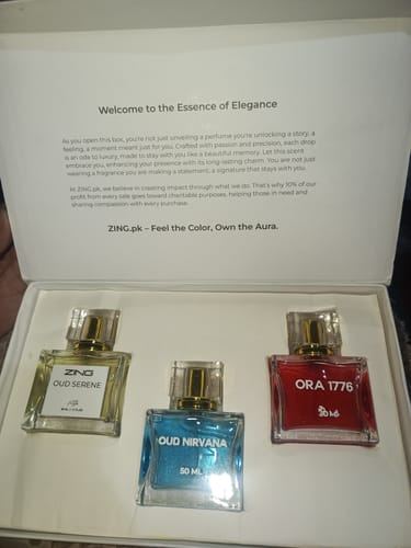 Reviewer's OUD Supreme BUNDLE showing three square perfume bottles—Serene, Nirvana, and Ora 1776—inside the open box.