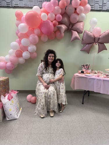 Reviewer wearing the Crinkled Chiffon Dress while pregnant, matching with her daughter at a baby shower.