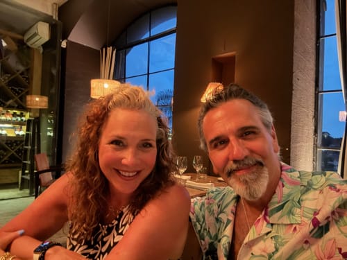 Reviewer smiling at a restaurant, showing results from the Anti-Aging Formula.