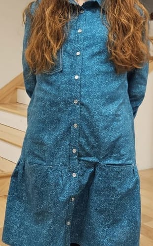 Reviewer wears a long-sleeved shirt dress made from the patterned Pebble Mosaic Dark Teal fabric.