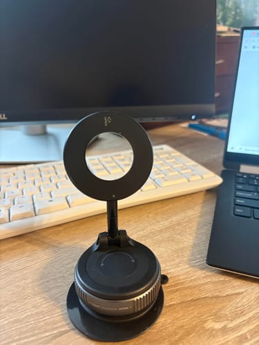 Customer's black MagMount Pro phone mount standing on a wooden desk next to a laptop and keyboard.