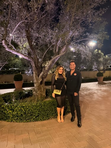 Customer wearing the black Taima High Neck Sheer Pointelle Midi Dress for a night out.