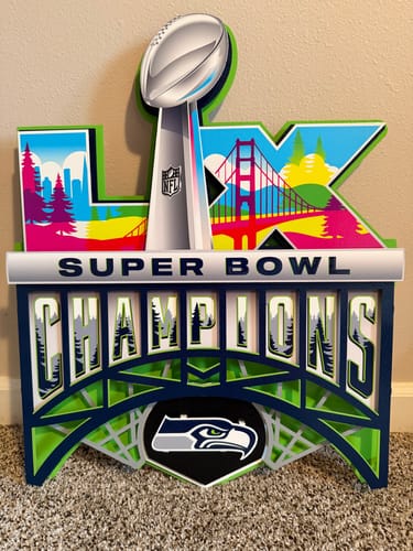 Reviewer's vibrant 3D metal art for the Seahawks' Super Bowl LX Championship, highlighting the trophy and team logo.