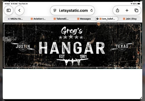 Reviewer's personalized black Hangar Sign II with a worn, distressed finish.