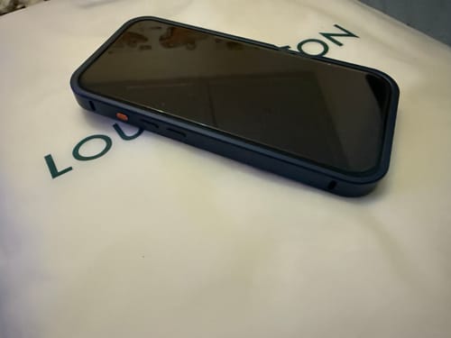 Customer's iPhone in the blue MagCase Metal, showing the protective aluminum frame from a side angle.