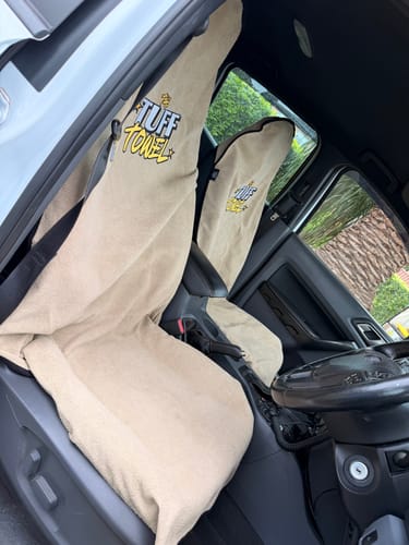 Customer's two beige Waterproof Car Towel Seat Covers installed on the front seats of a car.