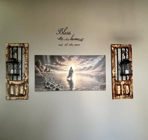 Customer's 'Walking on Water' wall art hanging on a foyer wall between two decorative sconces.