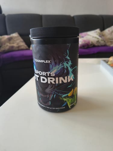 Customer's black tub of Complex Sports Iont Drink on a white table.