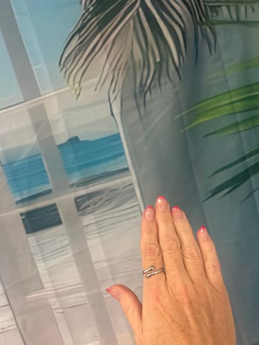 Reviewer's hand wearing the adjustable Hug From Heaven Ring.
