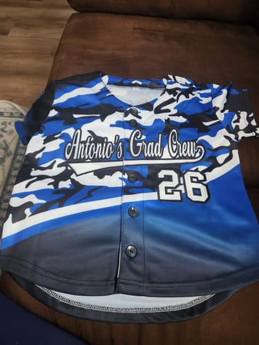 Customer's custom baseball jersey with a blue, black, and white camo pattern, personalized for "Antonio's Grad Crew 26".