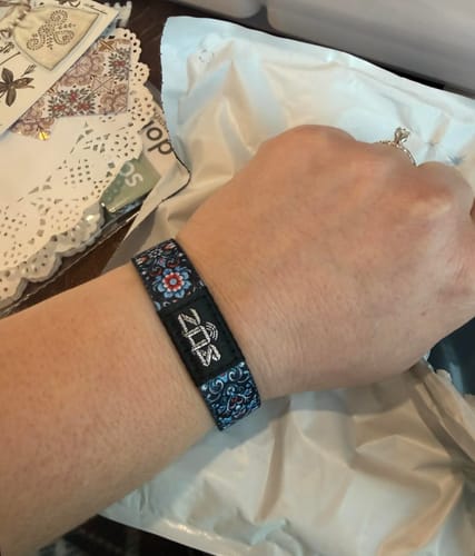 Customer wearing the patterned Grieving Is A Process Bracelet on their wrist.