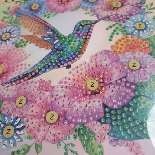 Customer's close-up of the Hummingbird Crystal Art Card Kit template, with the colorful hummingbird design ready for crystals.
