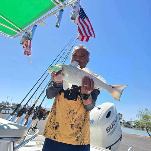 Customer on a boat showing the new replacement American Flag next to the tattered one.