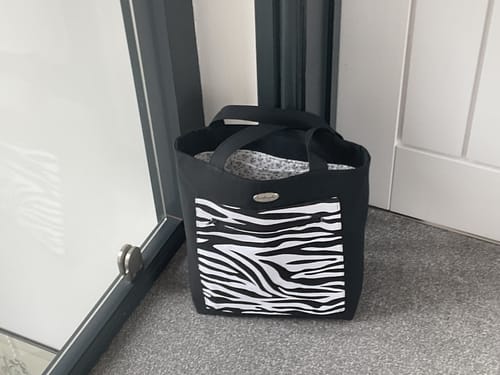 Reviewer's handmade tote bag using the black Heavy Suiting Panama fabric, shown with a zebra-print front pocket.