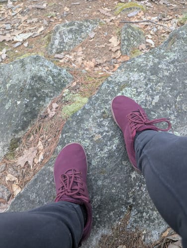 Reviewer's wine red Wish Ⅰ - Barefoot Shoes seen from above while standing on a large rock outdoors.