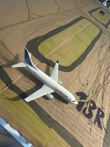 Reviewer's COPA AIRLINES SINGLE PLANE toy on a hand-drawn cardboard airport.
