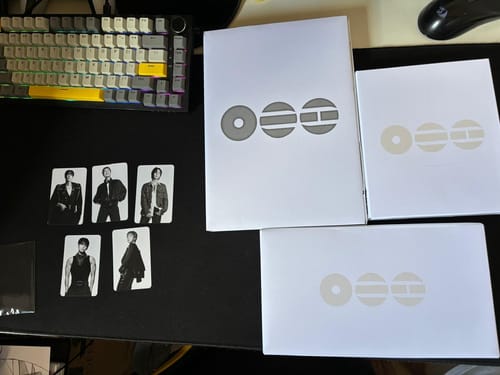 Customer's BTS ARIRANG 5TH ALBUM set displayed on a desk, showing three album boxes and five included photocards.