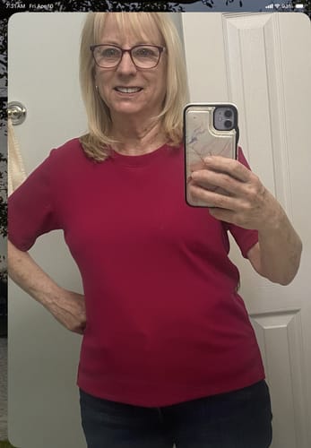 Customer showing the fit of her Delia Ribbed Short Sleeve top in a rich Poppy Spark color.