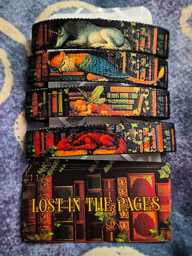 Customer's four woven Lost In The Pages bracelets showing the unicorn, griffin, fairy, and dragon designs.