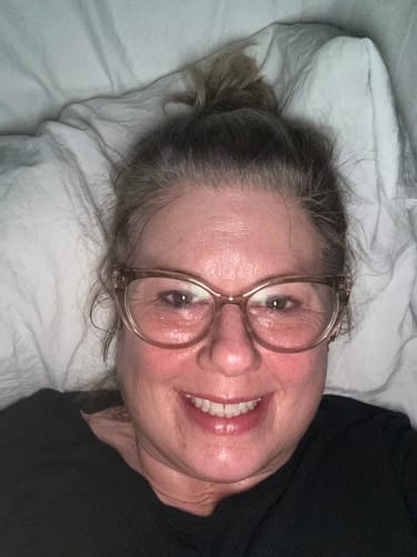 Close-up of a reviewer smiling, showing a moisturized face after using F-Balm.