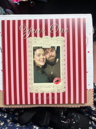 Customer's custom vinyl record with a striped cover featuring a photo of a couple and the text "Year One" for an anniversary.