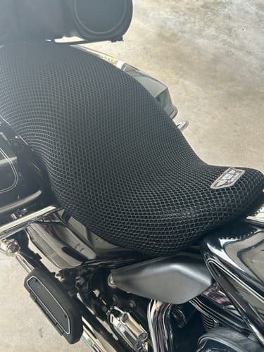 A customer's black Wind Rider Seat Cover with a honeycomb mesh texture installed on a motorcycle seat.