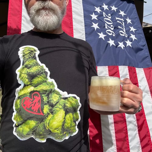 Partial view: Reviewer holding a mug with the Betsy Ross flag from the decor kit in the background.