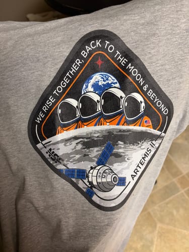Customer's review photo showing a close-up of the detailed Artemis II mission graphic on the grey t-shirt.