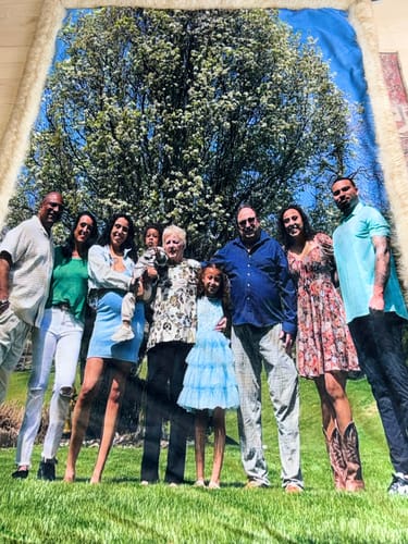 Reviewer's custom photo blanket showing a large family picture printed on the front with a fuzzy, teddy fur border.