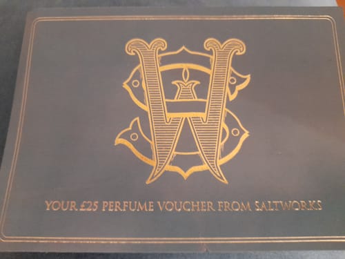 Customer's grey and gold £25 perfume voucher from Saltworks, included with the Discovery Set.