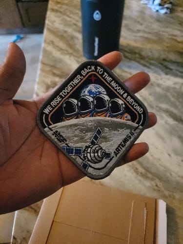 Customer holding the detailed Artemis II - Collectors Patch in their hand.
