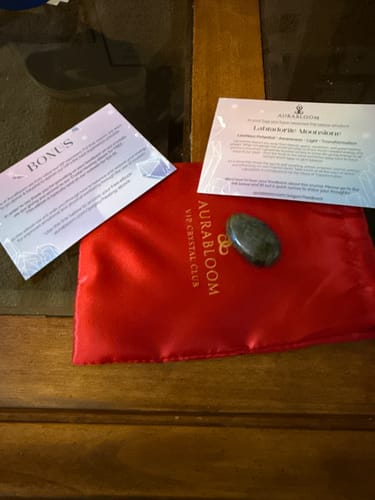 Customer's Labradorite Moonstone from the VIP Crystal Club shown with a red pouch and informational cards.