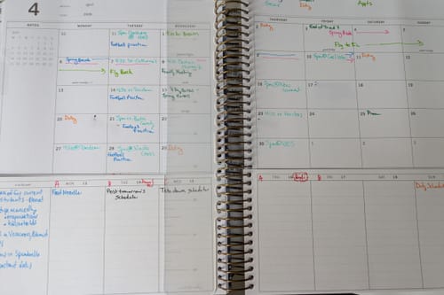 Customer's Scout Planner open to show the monthly-over-weekly layout filled with handwritten plans.