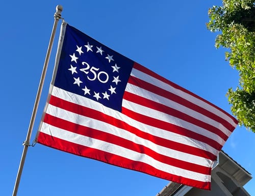 Close-up of the reviewer's America 250 Betsy Ross Flag showing the printed '250' design within the circle of stars.