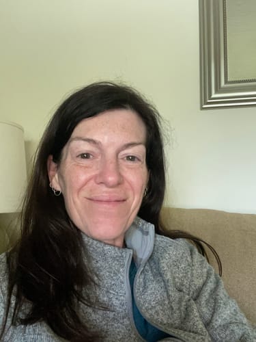 Reviewer's face showing radiant, glowing skin after using The Micro Infusion System.