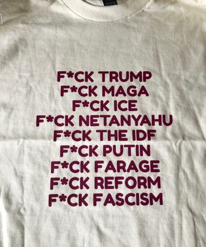 Close-up of a customer's off-white unisex t-shirt with a political statement printed in maroon.